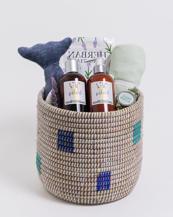 Fair trade woven basket filled with baby bedtime accessories